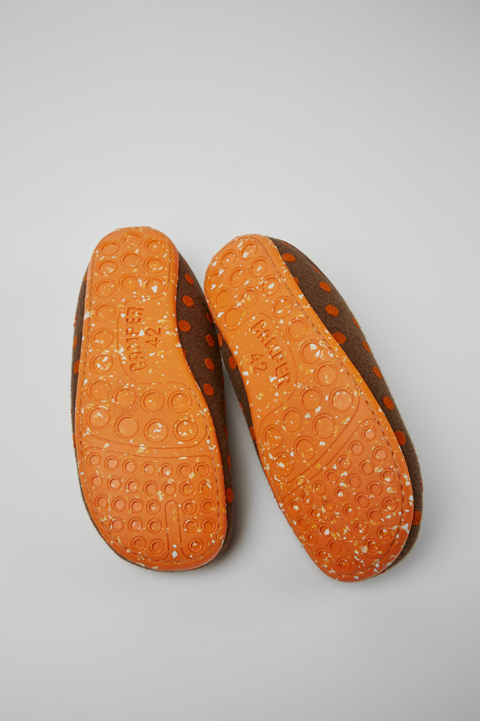 The soles of Wabi Brown and orange wool slippers for men