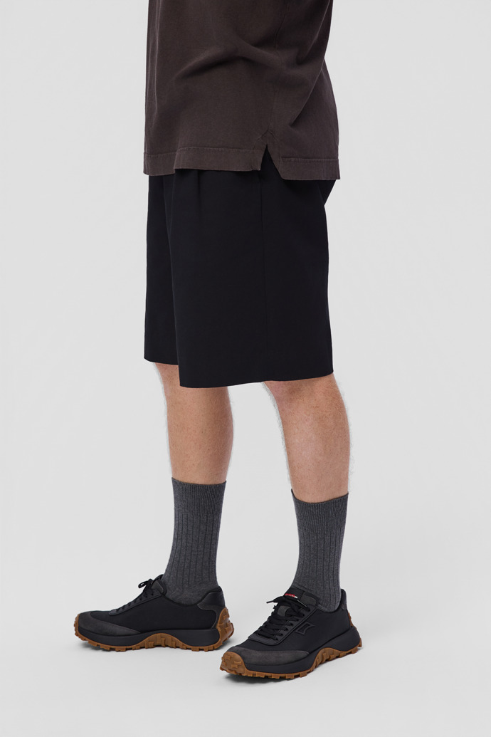 A model wearing Drift Trail Multicolor Textile and Nubuck Sneakers for Men.