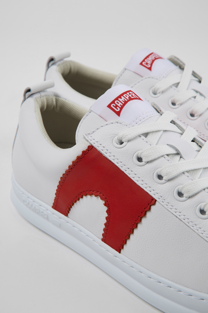 Close-up view of Runner White and red leather sneakers for men