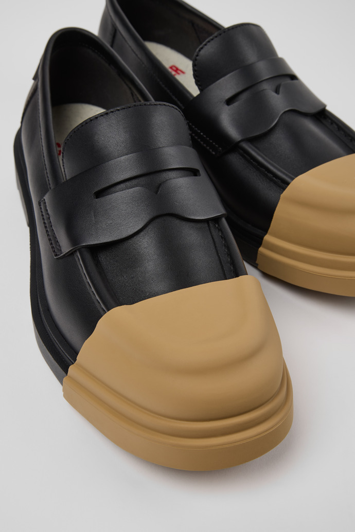 Close-up view of Junction Black Leather Moccasins and Nautical Shoes for Men.