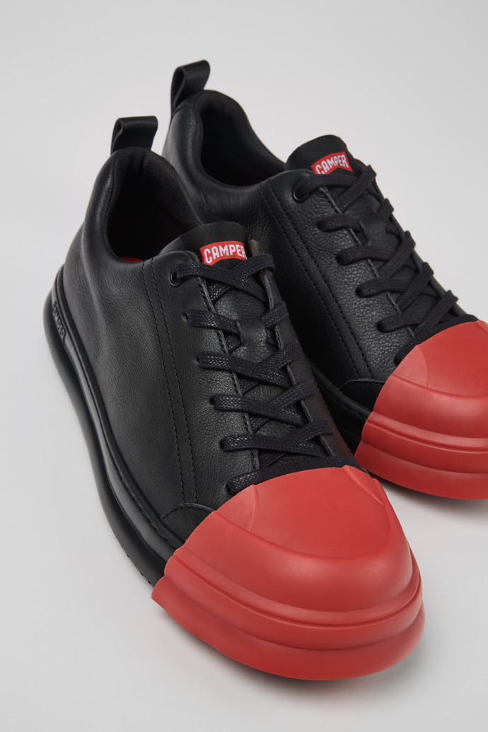 Close-up view of Junction Runner Black Leather Sneakers for Men.