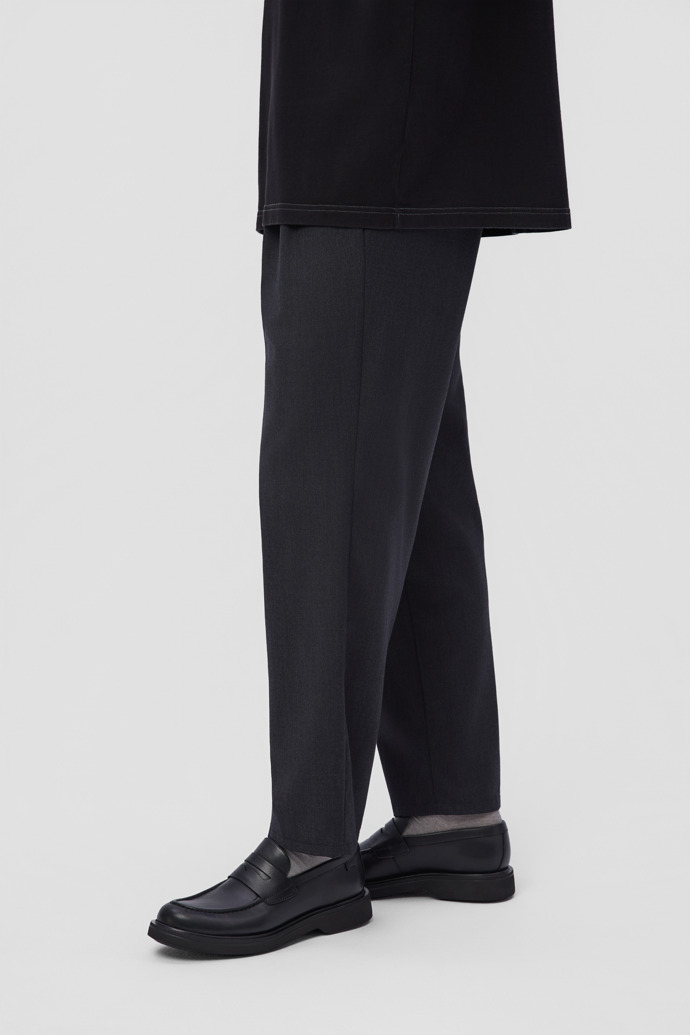 A model wearing Norman Black Leather Shoes for Men.