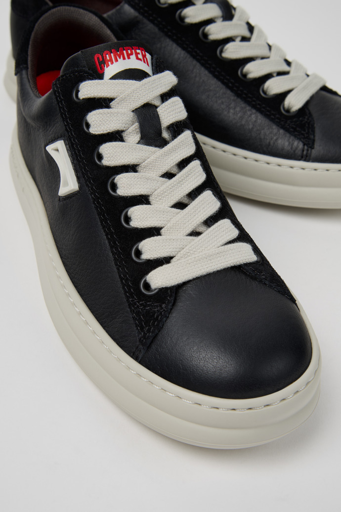 Close-up view of Runner Black Leather and Nubuck Sneakers for Men.