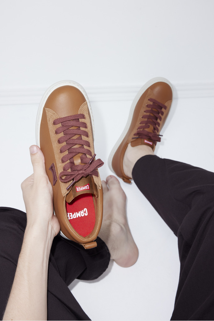 A model wearing Runner Brown Leather and Nubuck Sneakers for Men.