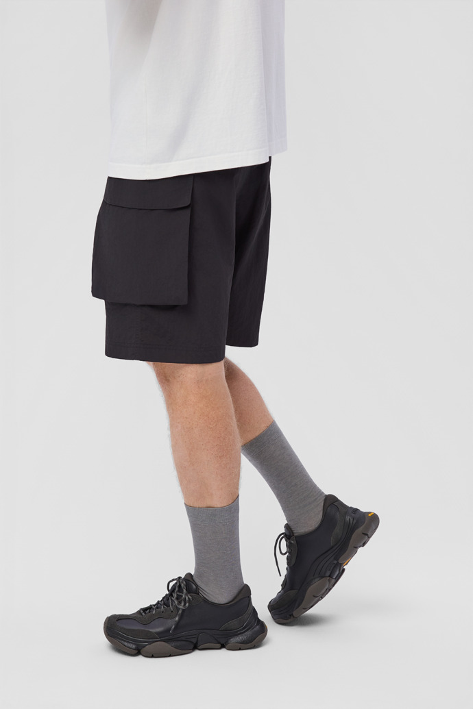 A model wearing Karst 2 Black and Gray Leather and Nubuck Sneakers for Men.