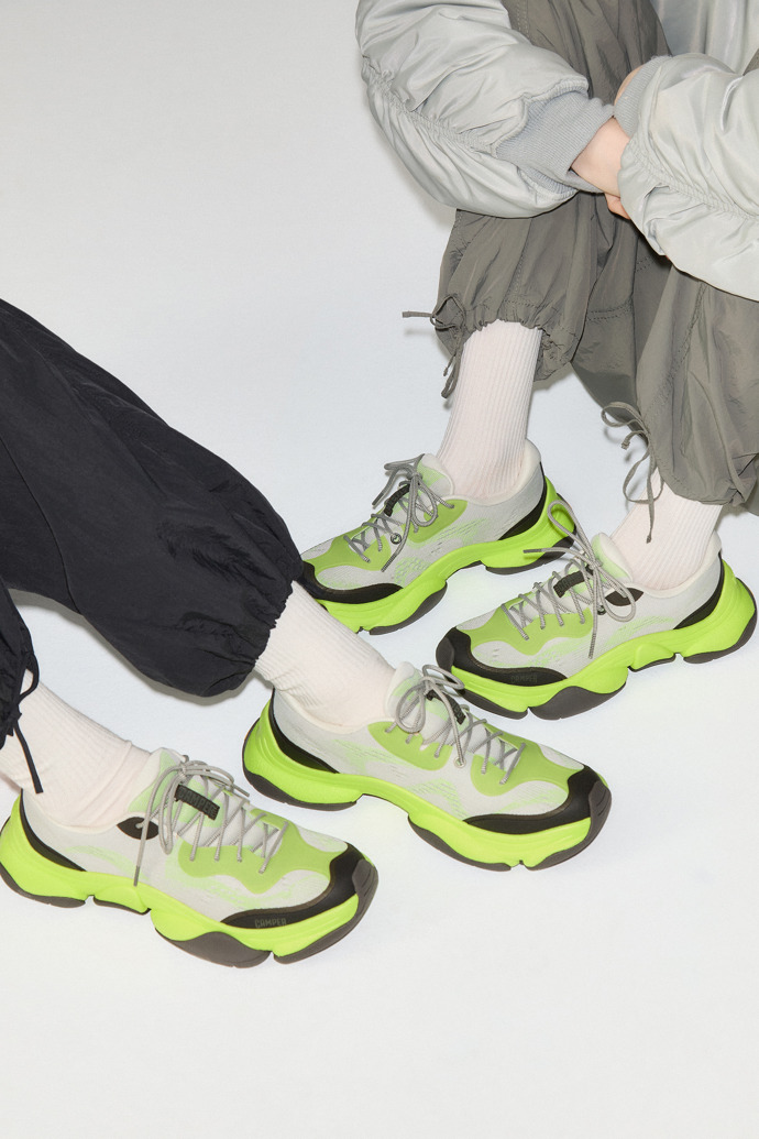 A model wearing Karst 2 Multicolor Engineered Sneakers for Men.