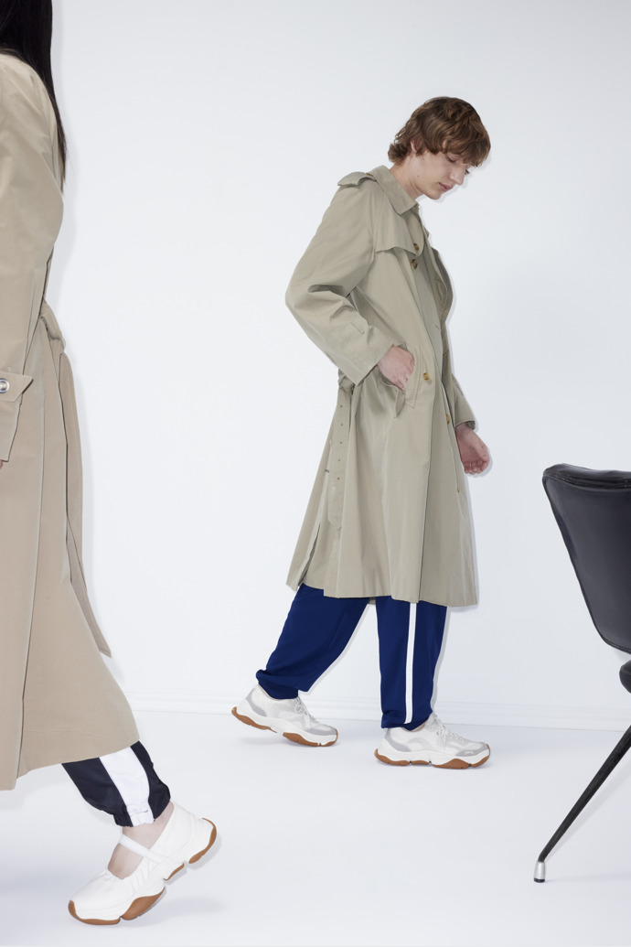 A model wearing Karst 2 White Recycled Engineered Materials Sneakers for Men.