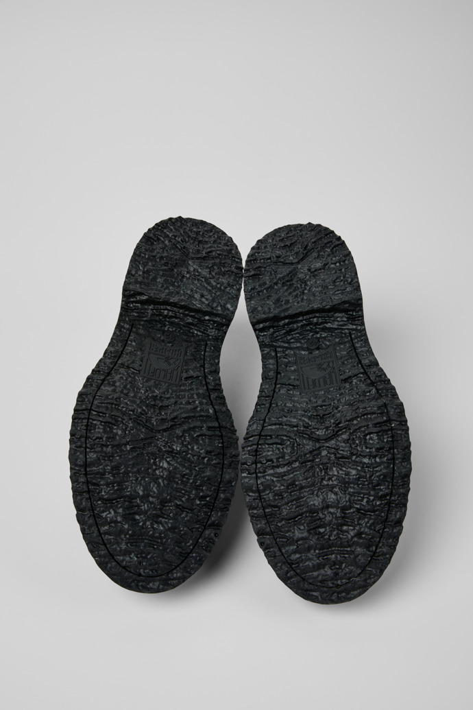 The soles of Twins Black and White Leather Nautical Shoes for Men.