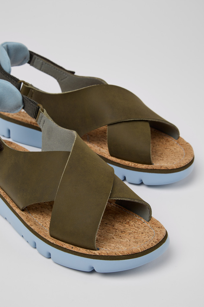 Close-up view of Oruga Green, blue, and grey sandals for women