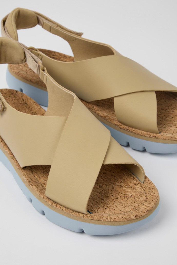 Close-up view of Oruga Beige leather and textile sandals for women