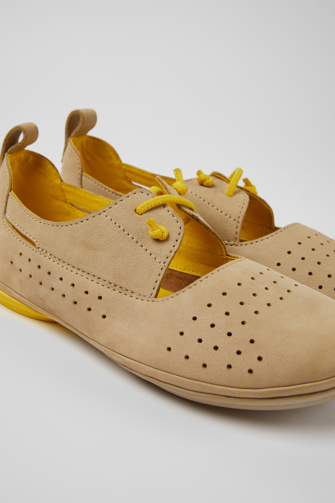 Close-up view of Right Beige and yellow nubuck shoes for women