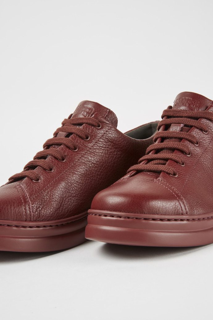 Close-up view of Runner Up Burgundy leather sneakers