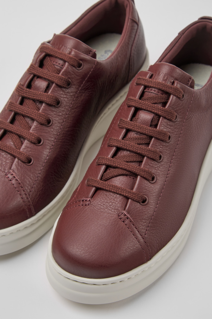 Close-up view of Runner Up Burgundy leather women's sneakers