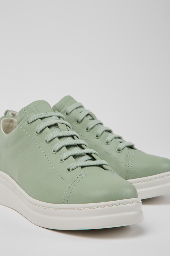 Close-up view of Runner Up Green leather sneakers for women