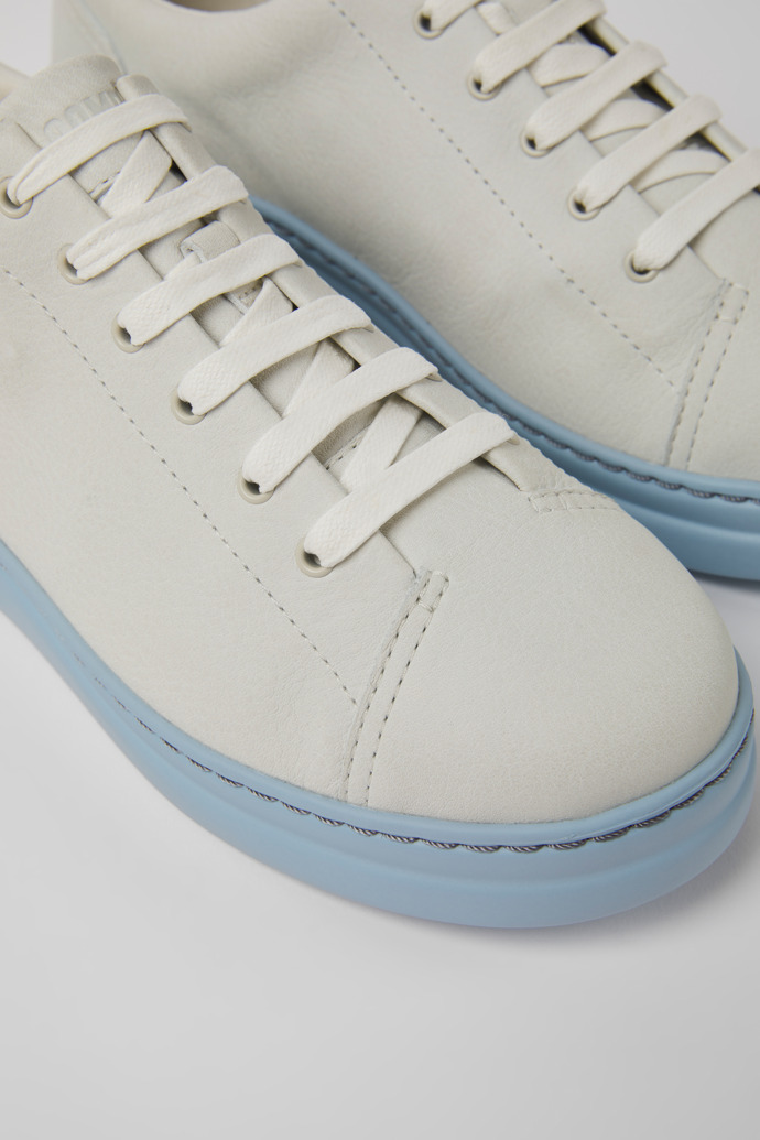 Close-up view of Runner Up White and blue non-dyed leather sneakers for women