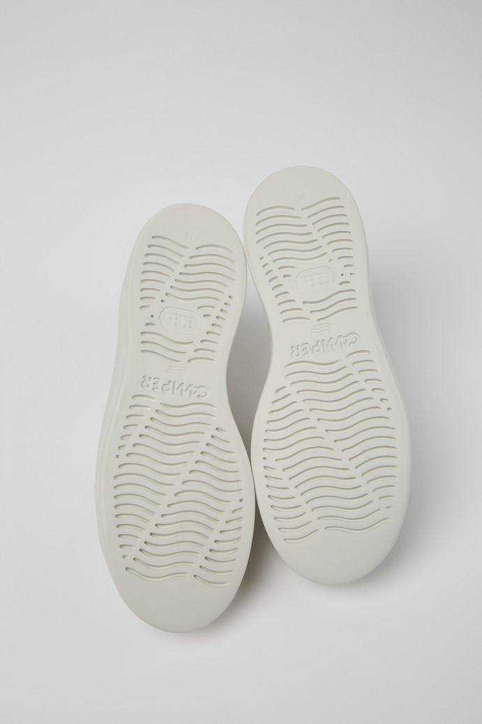 The soles of Runner Up White Leather Sneaker for Women