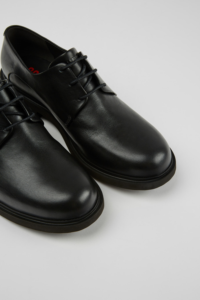 Close-up view of Neuman Black leather lace-up shoes
