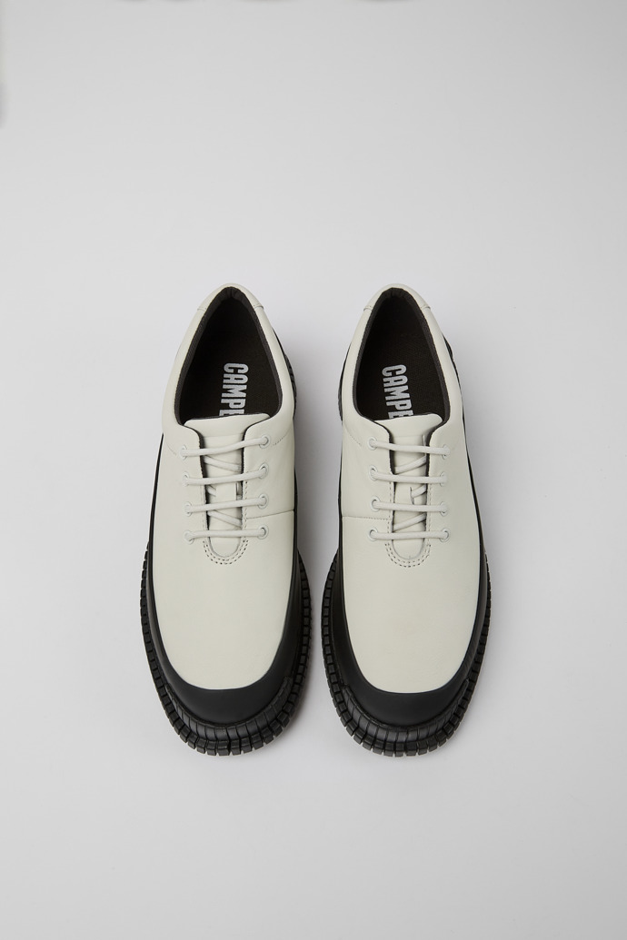 Overhead view of Pix White and black leather lace-up shoes