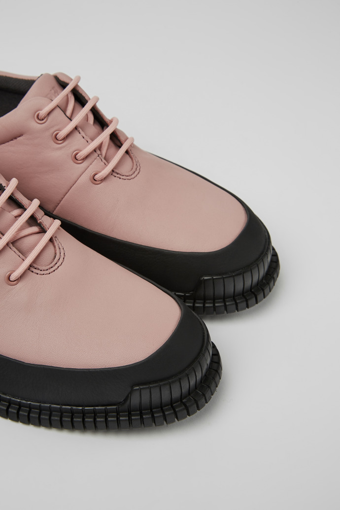 Close-up view of Pix Pink and black leather lace-up shoes for women