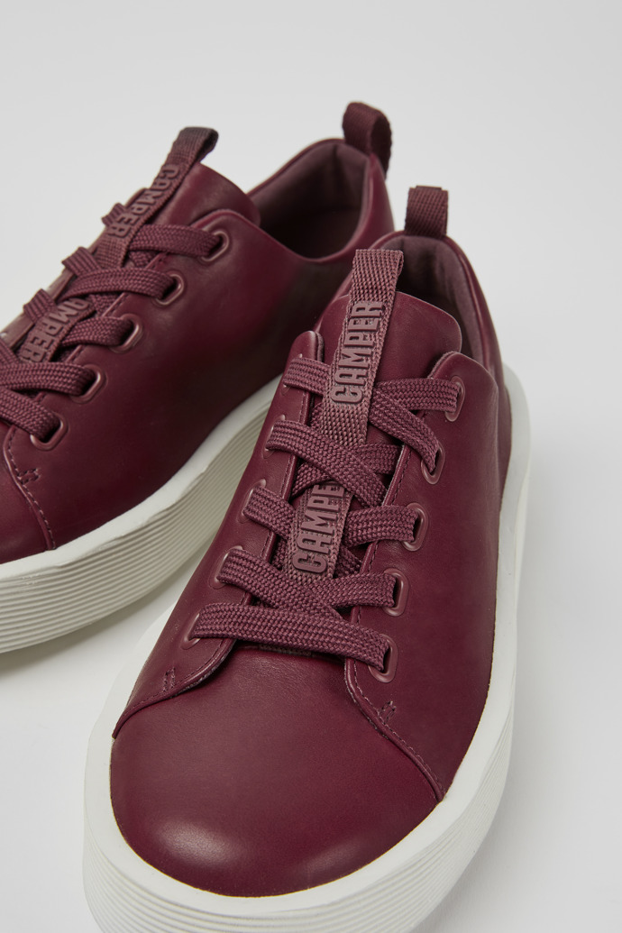 Close-up view of Courb Burgundy leather sneakers for women