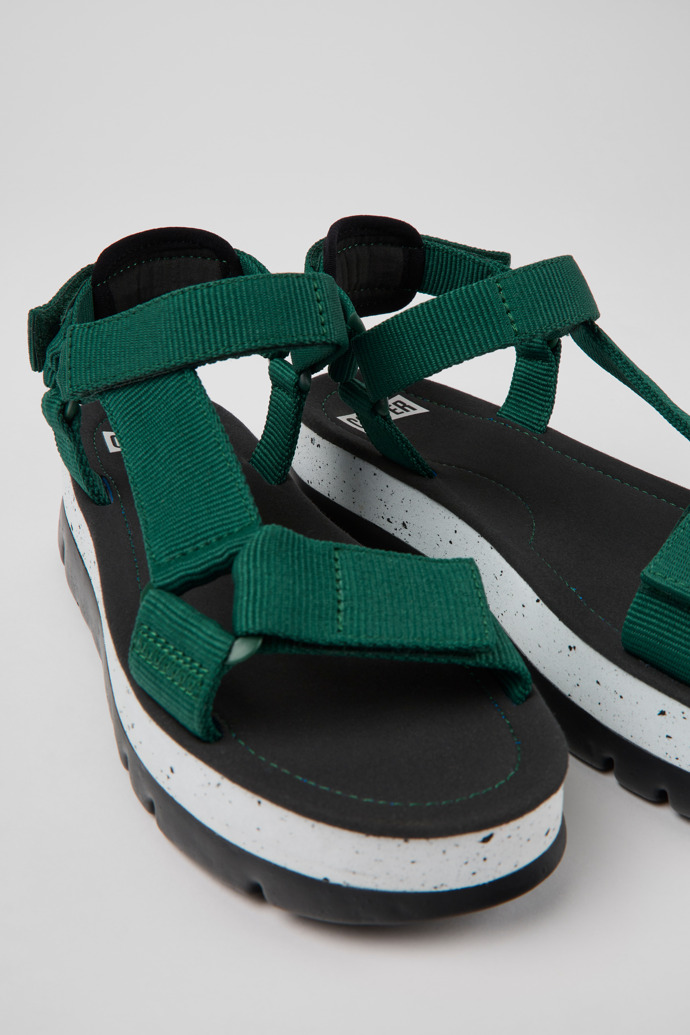 Close-up view of Oruga Up Green textile sandals for women