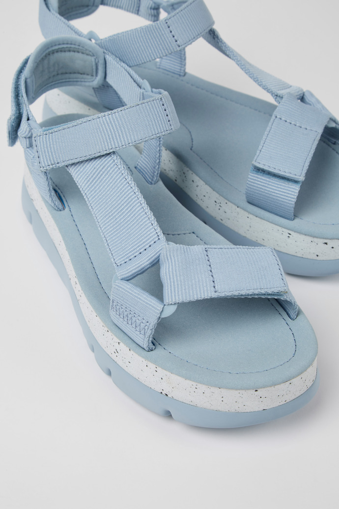 Close-up view of Oruga Up Blue textile sandals for women