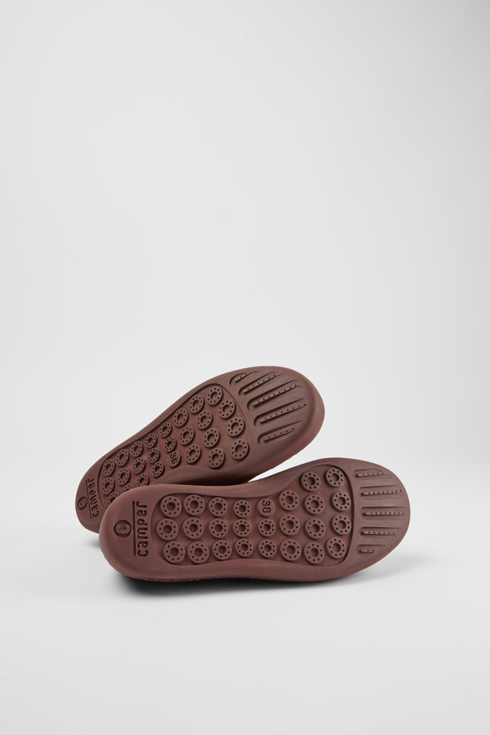 The soles of Peu Touring Burgundy suede sneakers