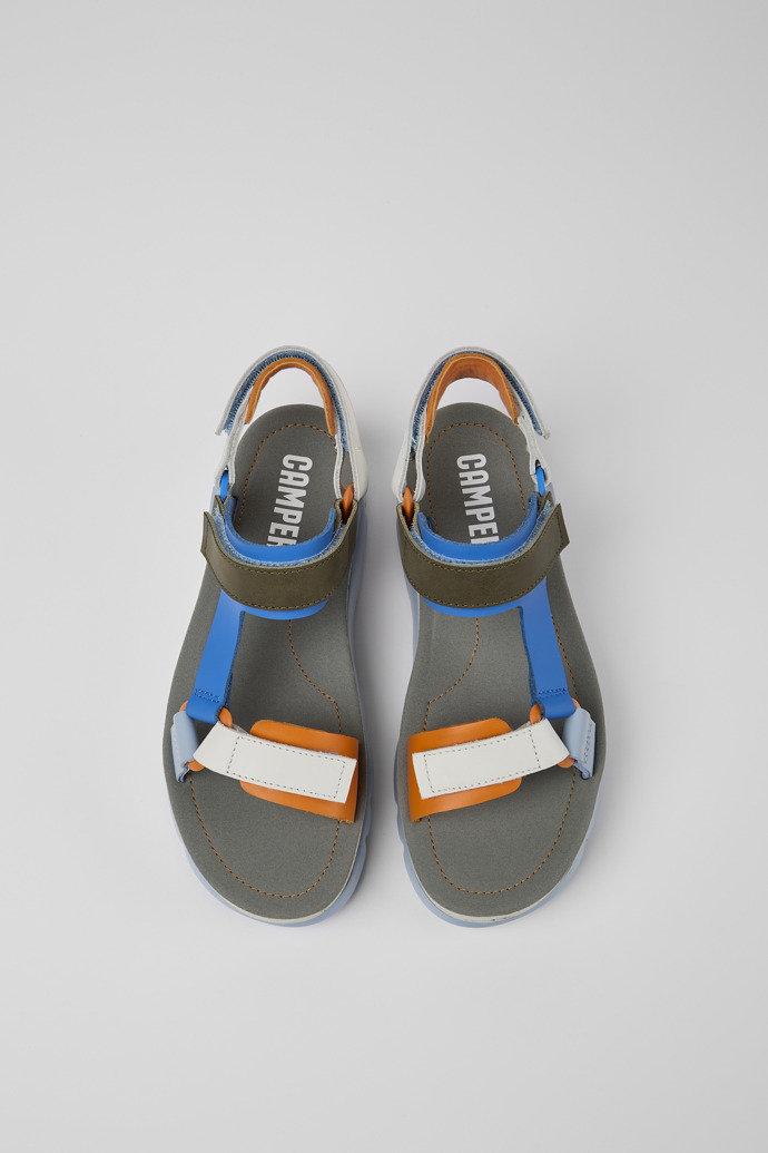 Overhead view of Oruga Up Blue, orange, and white leather sandals for women