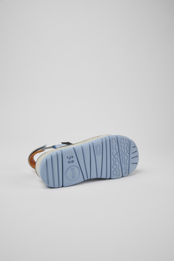 The soles of Oruga Up Blue, orange, and white leather sandals for women