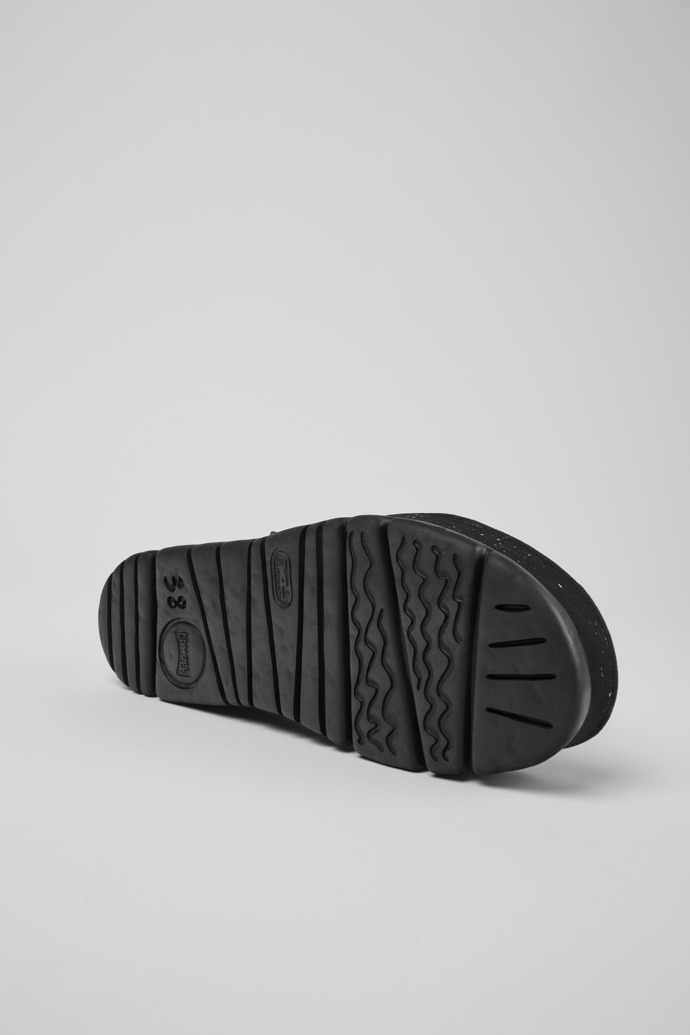 The soles of Oruga Up Black, brown, and green leather sandals for women