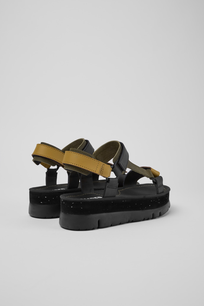 Back view of Oruga Up Black, brown, and green leather sandals for women