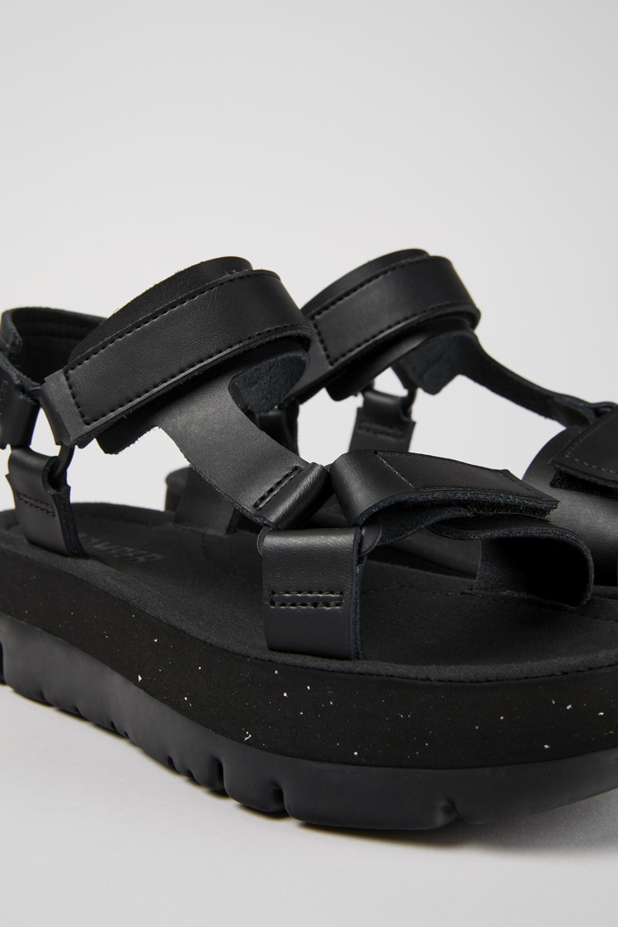 Close-up view of Oruga Up Black leather sandals for women