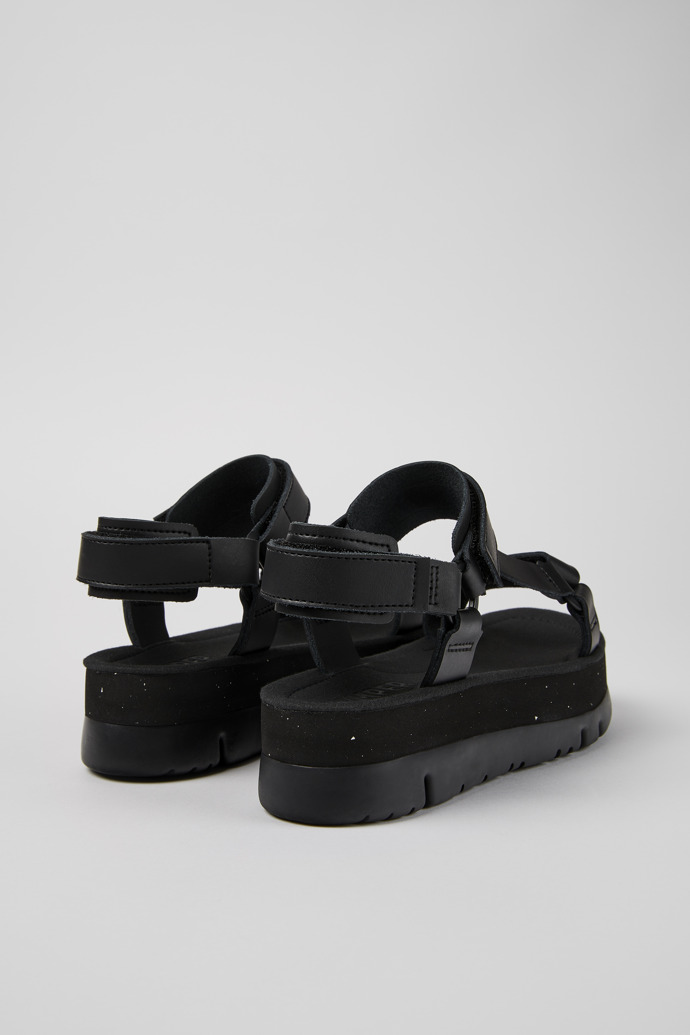 Back view of Oruga Up Black leather sandals for women