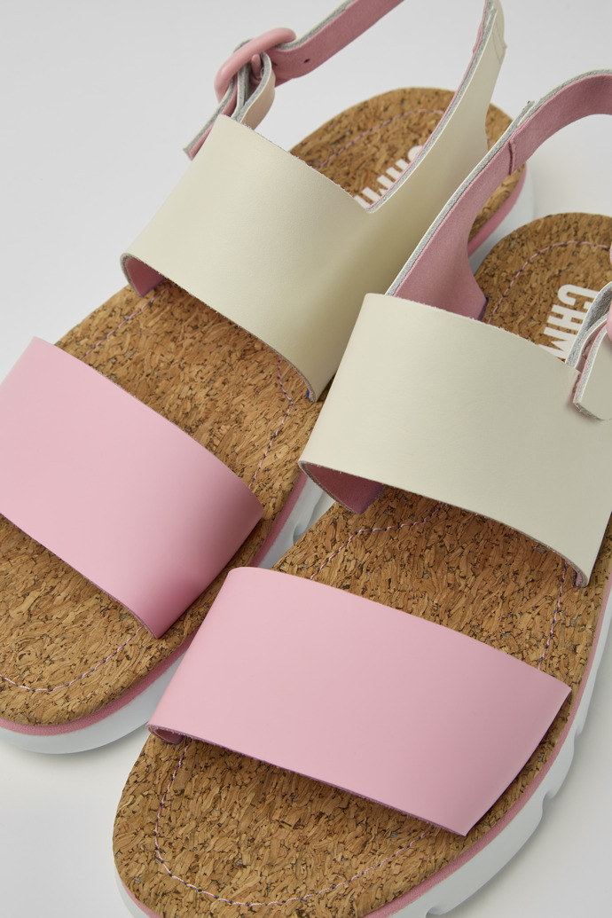 Close-up view of Oruga White and pink leather sandals for women
