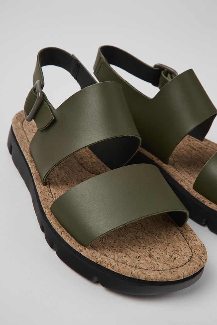 Close-up view of Oruga Green leather sandals for women