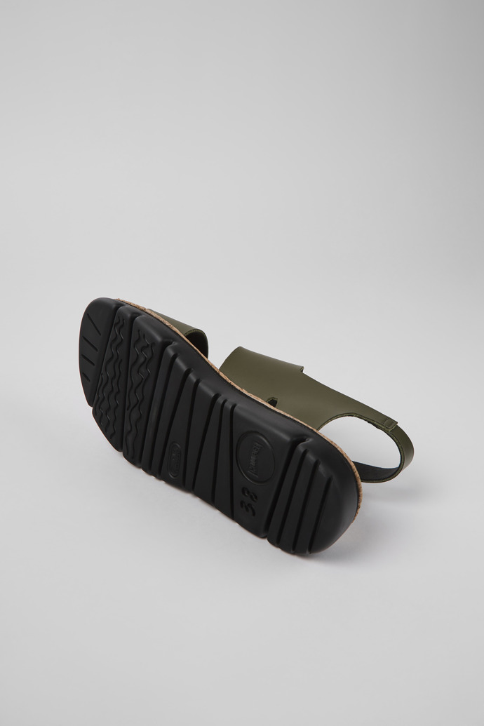 The soles of Oruga Green leather sandals for women
