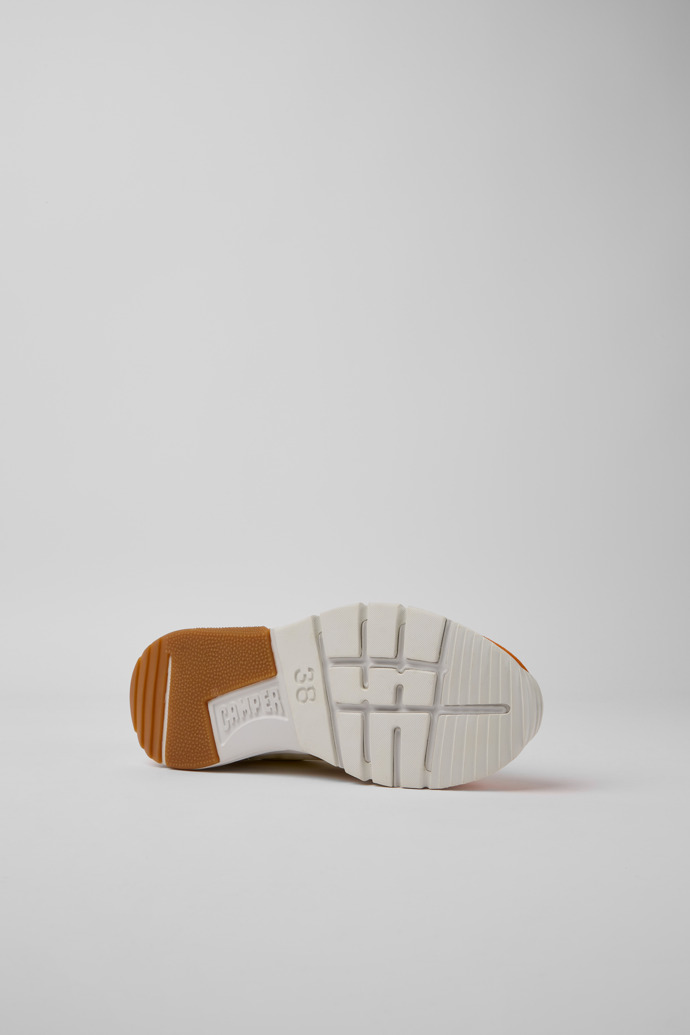 The soles of Drift White, beige, and orange nubuck sneakers for women