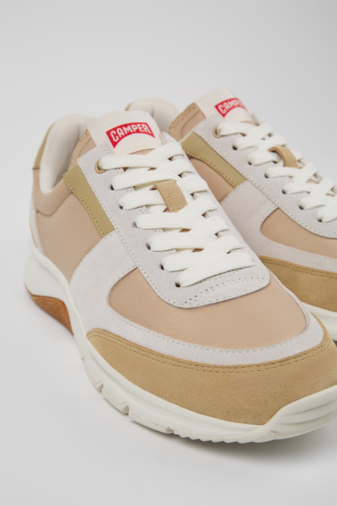 Close-up view of Drift Beige, white, and brown sneakers for women