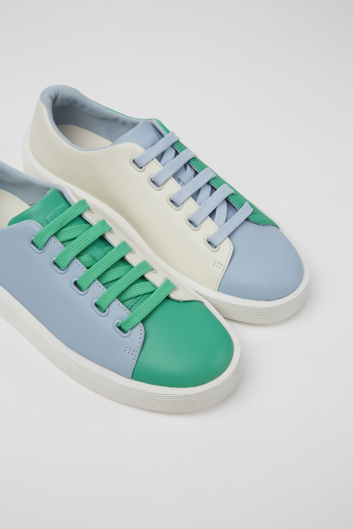 Close-up view of Twins Green, blue, and white leather sneakers for women