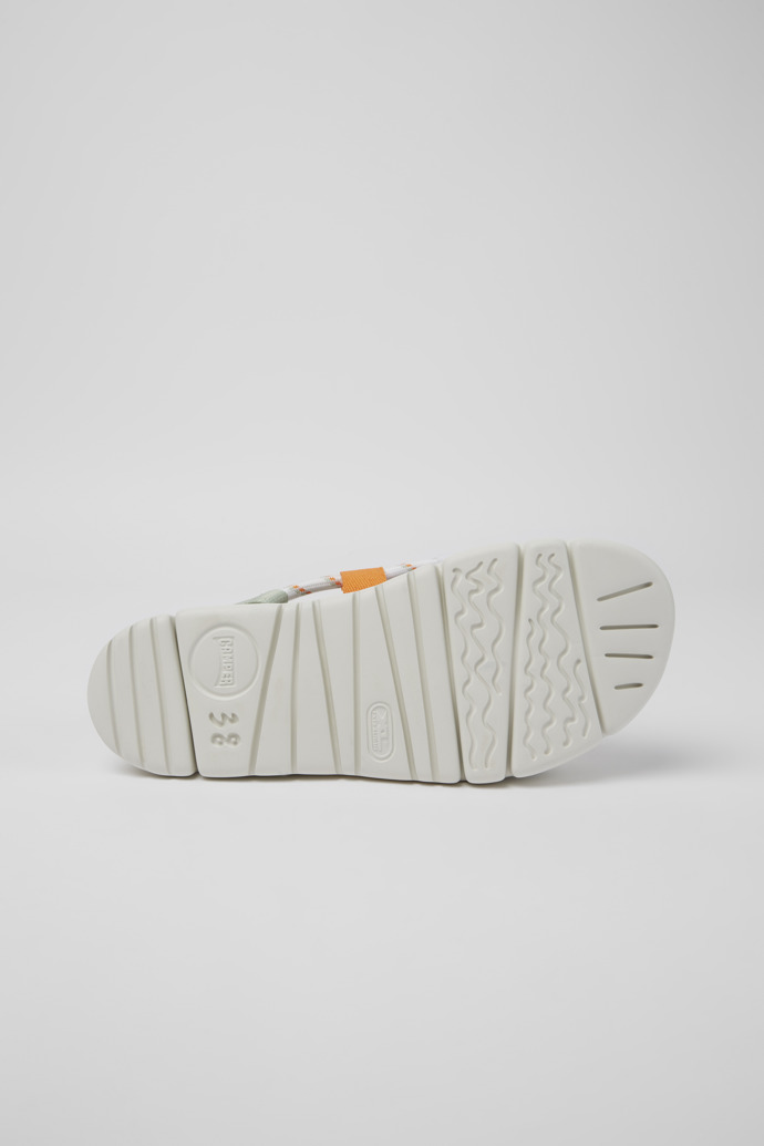 The soles of Oruga White, green, and orange sandals for women