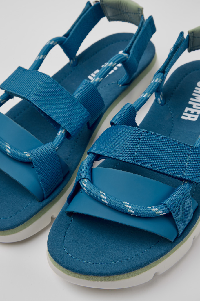 Close-up view of Oruga Blue and green leather sandals for women