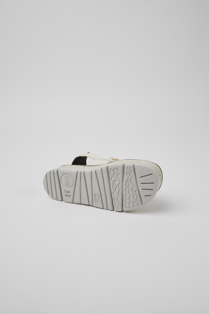 The soles of Oruga Up White and black leather sandals for women