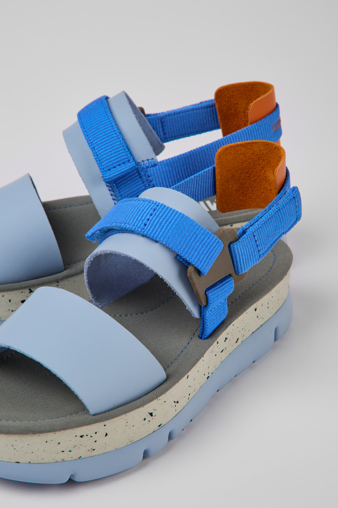 Close-up view of Oruga Up Blue and orange leather sandals for women