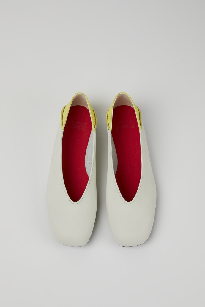Overhead view of Casi Myra White and yellow leather ballerina flats for women