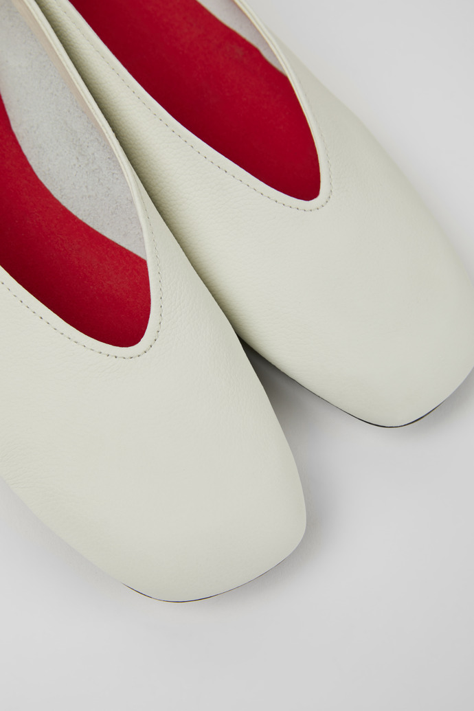 Close-up view of Casi Myra White and yellow leather ballerina flats for women