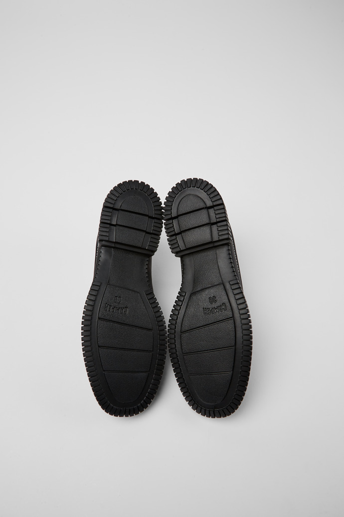 The soles of Pix Black lace up shoes