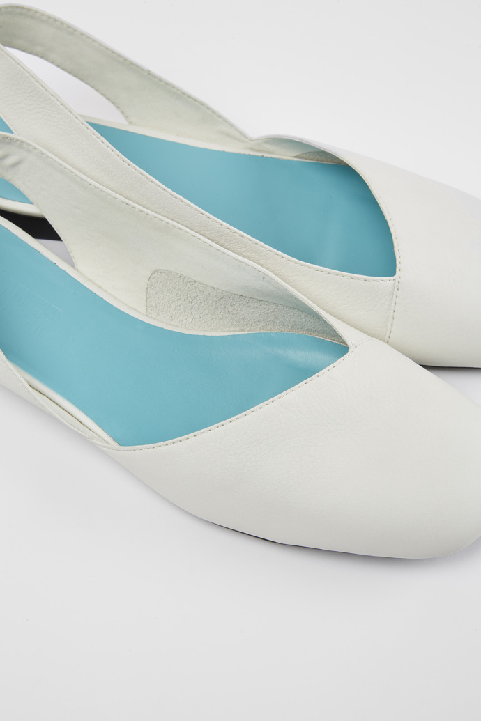 Close-up view of Casi Myra White semi-open ballerinas