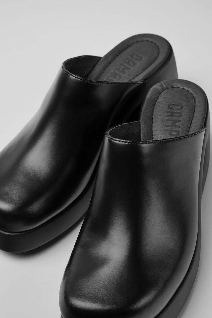 Close-up view of Kaah Black leather clogs