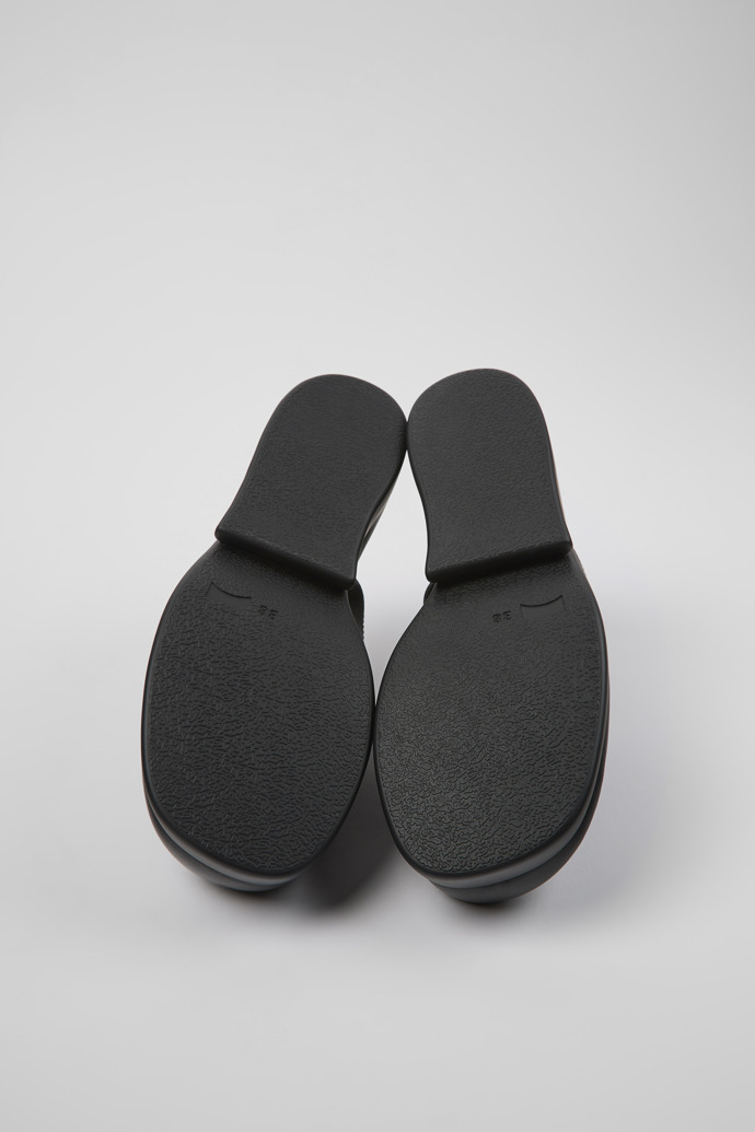 The soles of Kaah Black leather mules for women