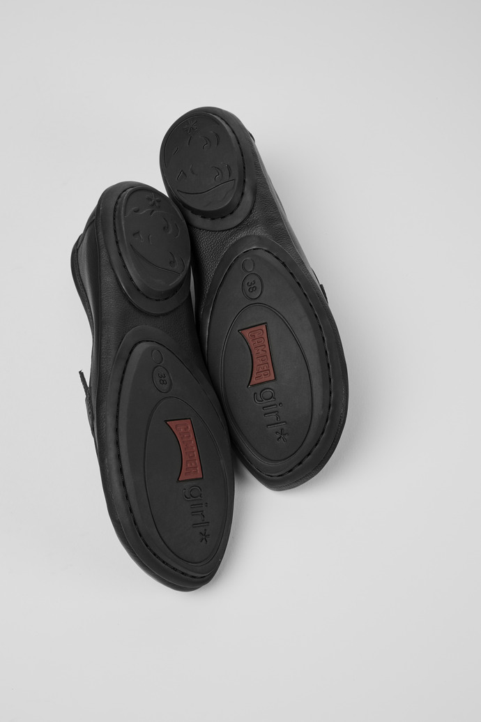 The soles of Twins Black leather moccasins